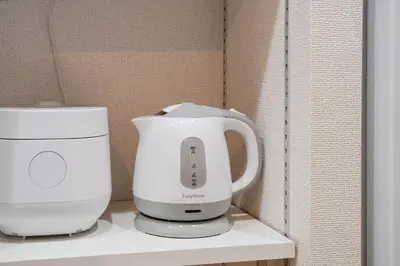 a white appliance sitting on top of a shelf at Terrace Tokyo Otsuka South in Tokyo