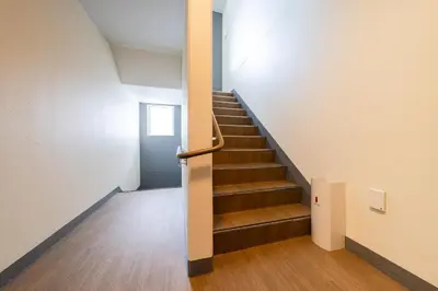 a staircase in an office building with a stair case at Terrace Tokyo Otsuka South in Tokyo