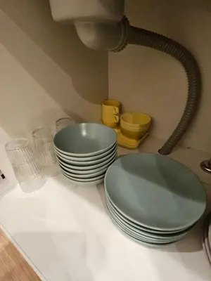 a counter with plates and drinking glasses and a sink at Asakusa Stay \u897f\u6d45\u8349 in Tokyo