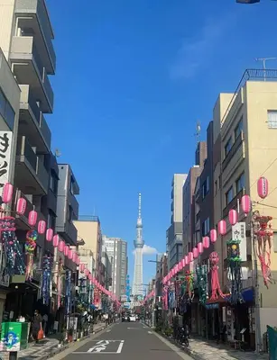 a street in a city with a view of the television tower at Asakusa Stay \u897f\u6d45\u8349 in Tokyo