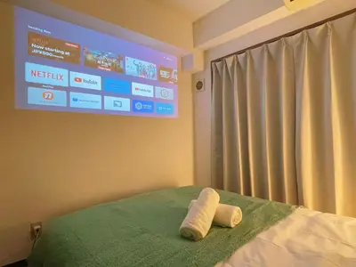a hospital room with a tv and two towels on a bed at Home Story in Tokyo KANAMETYOU&Ikebukuro-Ginnzaまで直通&東京屋語 in Tokyo