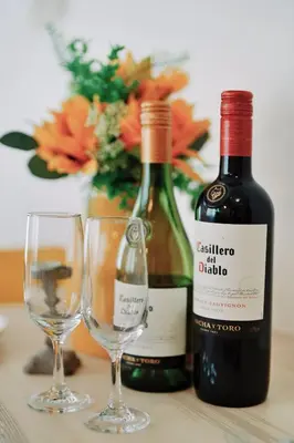 two bottles of wine and two glasses on a table at Home Story in Tokyo KANAMETYOU&Ikebukuro-Ginnzaまで直通&東京屋語 in Tokyo