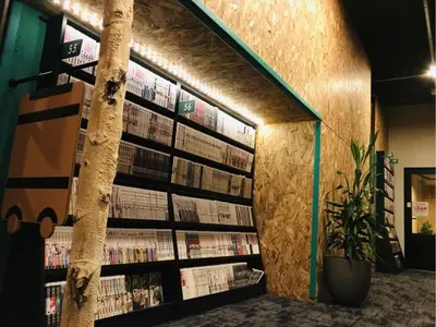 a library with book shelves filled with books at eeGee STAY Kamata