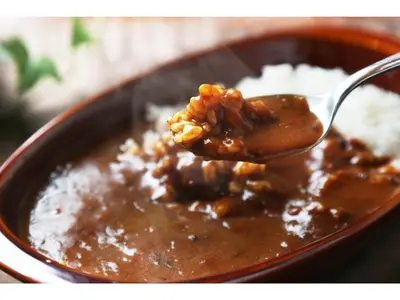 a spoonful of chili and rice in a bowl at eeGee STAY Kamata