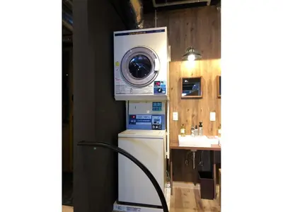 a washing machine sitting on top of a refrigerator at eeGee STAY Kamata