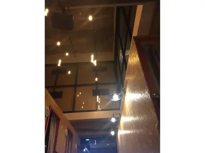 a hallway with lights hanging from a ceiling at eeGee STAY Kamata