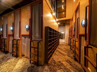 a row of wine racks in a room at eeGee STAY Kamata