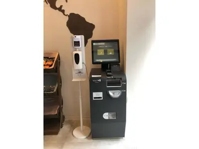 an atm machine with a computer on a wall at eeGee STAY Kamata