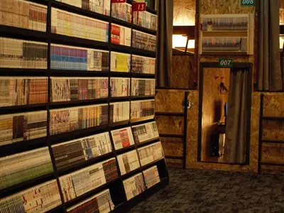a room with stacks of books on the wall at eeGee STAY Kamata