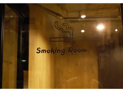 a window with a smoking room sign on it at eeGee STAY Kamata