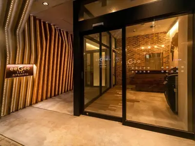a store front with glass doors and a store sign at eeGee STAY Kamata