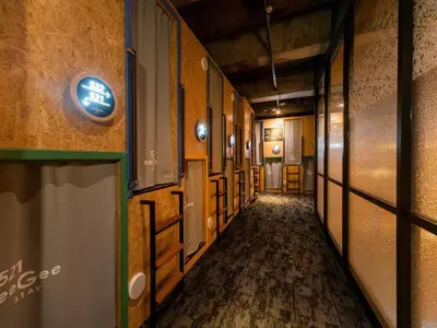 an empty hallway with a sign on the wall at eeGee STAY Kamata