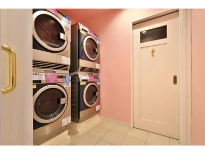 a laundry room with two washing machines and a door at FourStoriesHotelMaihama Tokyo Bay - Vacation STAY 73101v in Tokyo