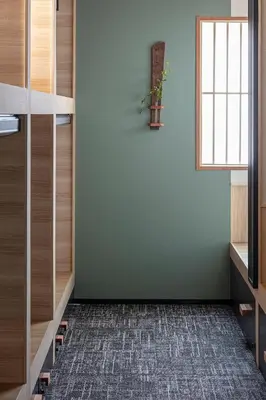 a room with a green wall and a potted plant on a window at ENSO TOKYO Akasaka in Tokyo