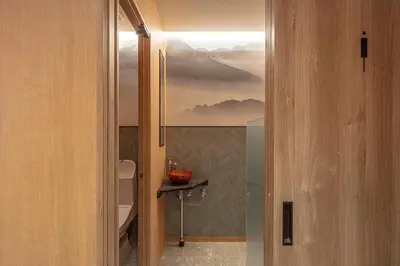 a bathroom with a shower with a painting on the wall at ENSO TOKYO Akasaka in Tokyo
