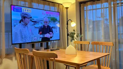 a television screen in a dining room with a table at TD Link Ooyama Cozy Escape Sleeps 8 Direct to Ikebukuro in Tokyo