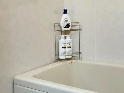 a bathroom with a white tub and a rack with bottles on it at TD Link Ooyama Cozy Escape Sleeps 8 Direct to Ikebukuro in Tokyo