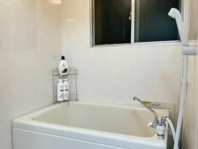 a white bath tub in a bathroom with a window at TD Link Ooyama Cozy Escape Sleeps 8 Direct to Ikebukuro in Tokyo