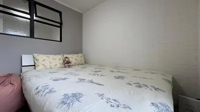 a bed with a teddy bear sitting on top of it at Cozy corner in Tokyo