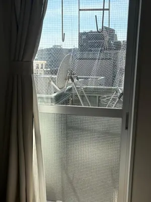 a window with a view of a city at Cozy corner in Tokyo