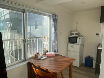 a small kitchen with a wooden table and a window at Cozy corner in Tokyo
