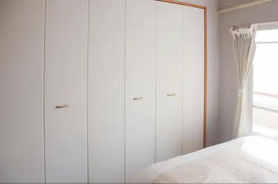 a bedroom with white cabinets and a bed at Shibuya-E604 in Tokyo