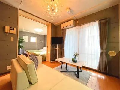 a living room with a couch and a table at Amika First 101 AF11 in Tokyo