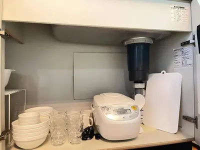 a kitchen counter with a mixer and plates and cups at Amika First 101 AF11 in Tokyo