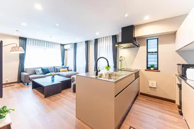 a kitchen and living room with a couch and a table at Poka Villa Aoyama in Tokyo