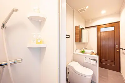 a small bathroom with a toilet and a sink at Poka Villa Aoyama in Tokyo