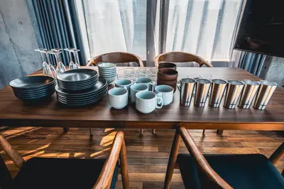 a wooden table with plates and cups on it at Rimba Tokyo Oshiage, Skytree view, 3BR 80m2 in Tokyo