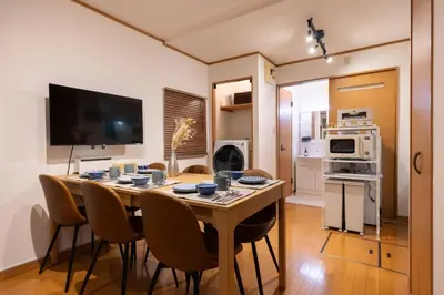 a kitchen and dining room with a table and chairs at House Hotel Kagurazaka HHK1 in Tokyo