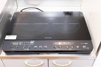 a black microwave oven sitting on top of a counter at House Hotel Kagurazaka HHK1 in Tokyo