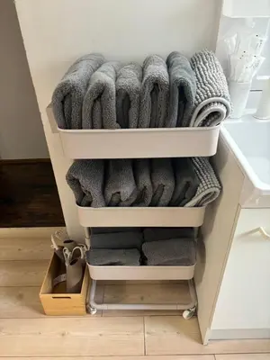 a drawer filled with towels in a closet at Flower House in Tokyo