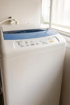 a white refrigerator with a blue lid next to a window at Flower House in Tokyo