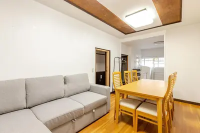 a living room with a couch and a table at Flower House in Tokyo