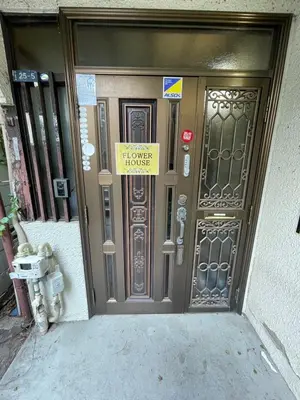 a house door with a sign on it at Flower House in Tokyo