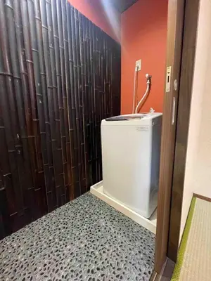 a bathroom with a shower with a toilet in it at Ninja House in Tokyo