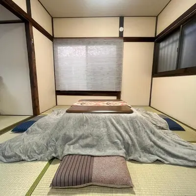 a room with a large bed in the middle at Ninja House in Tokyo