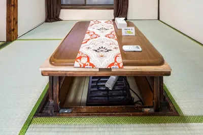 a wooden table in the middle of a room at Ninja House in Tokyo