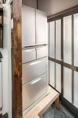 a white refrigerator in a kitchen next to a window at Ninja House in Tokyo