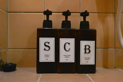 three bottles of soap sitting on top of a bathroom counter at Momiji Hotel in Tokyo