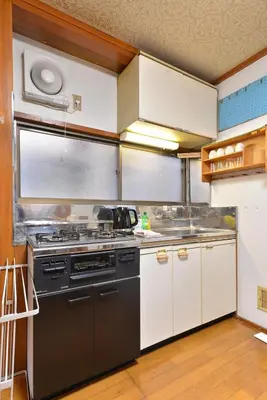 a kitchen with a stove and a sink at \u693f Tubaki in Tokyo