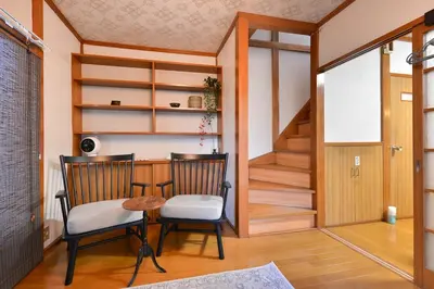 a dining room with two chairs and a table at \u693f Tubaki in Tokyo