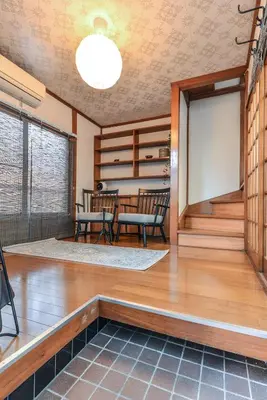 a living room with a table and chairs at \u693f Tubaki in Tokyo