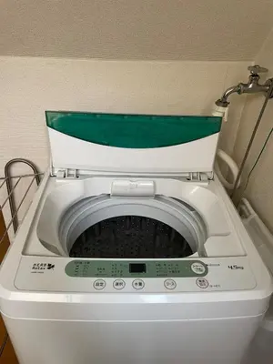 a washing machine with a green lid in a bathroom at Yellow House in Tokyo