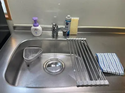 a sink with a strainer in the middle of it at Yellow House in Tokyo