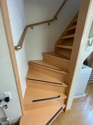 a stairway with wooden treads in a house at Yellow House in Tokyo