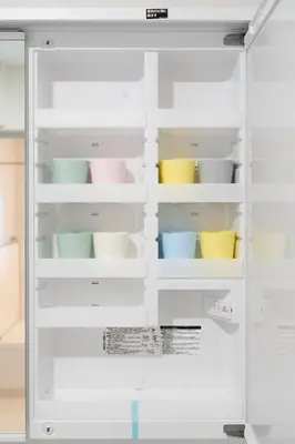 a white refrigerator with colorful dishes in it at Magazine Home Tokyo Spacious 93 3BR Skytree7 minutesAsakusa12 minutes by train in Tokyo
