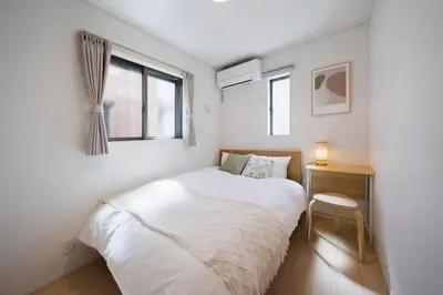 a small bedroom with a white bed and a window at Magazine Home Tokyo Spacious 93 3BR Skytree7 minutesAsakusa12 minutes by train in Tokyo